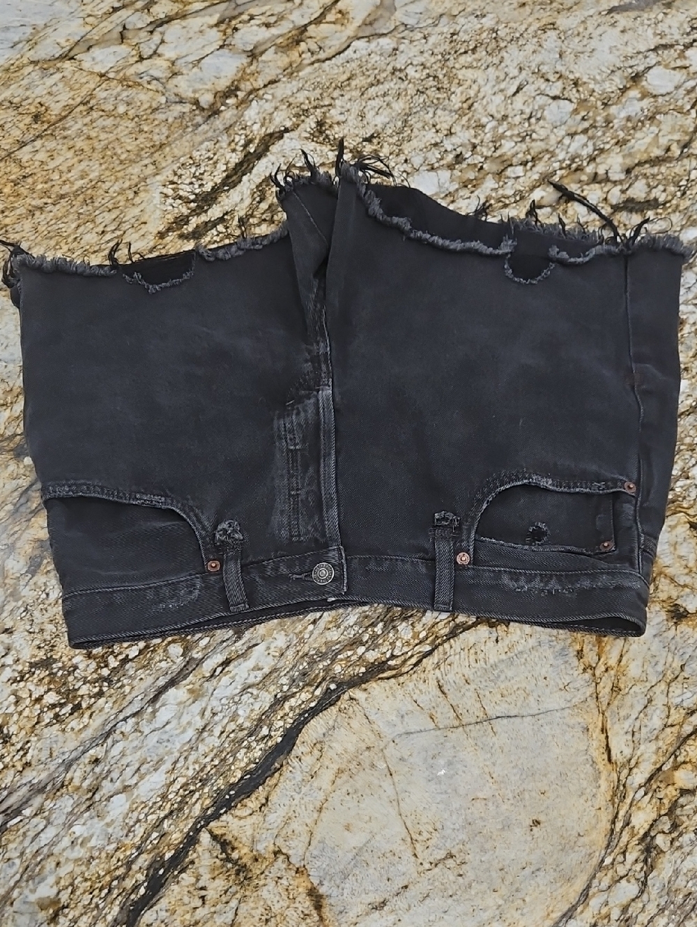 We The Free black denim shorts with frayed trim. Size 32